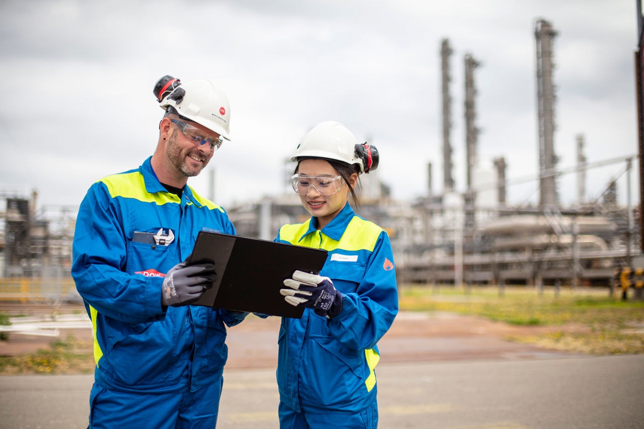 Two people talking at factory