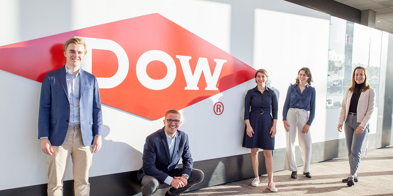 Four colleagues posing for a photo in front of the Dow Diamond