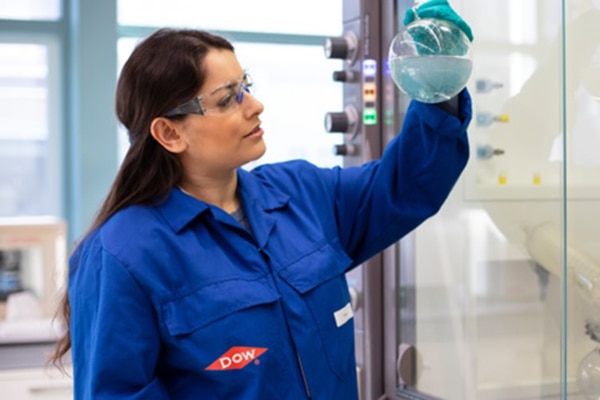Dow scientist inspects a material in a lab