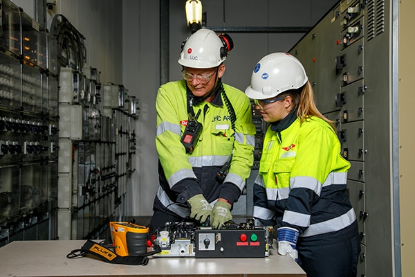 Electrical engineers work on a piece of equipment