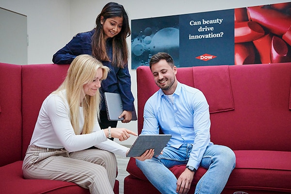 Three colleagues looking at a tablet